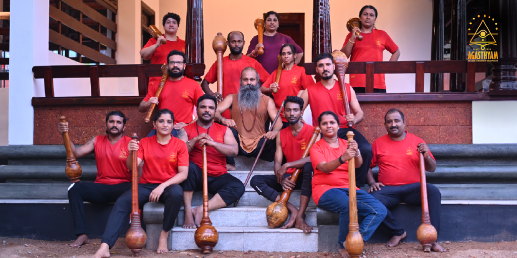 Agasthyam Kalari practitioners and students posing with traditional Gada weapons at the Kalari school
